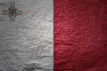 big national flag of malta on a grunge old paper texture background