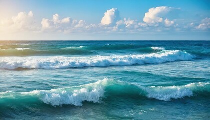 waves of ocean water or sea in summer bright blue and turquoise colors in early morning sun light cloudy sky background