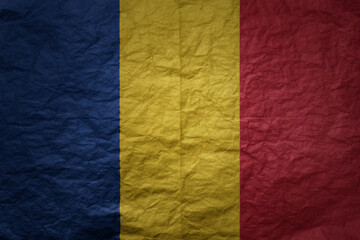 big national flag of romania on a grunge old paper texture background