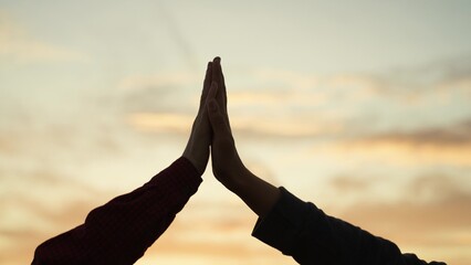 High five hands at sunset silhouette. Best friends buddies clapping each other palms in field park at dawn. Teamwork successfully completed business celebration rejoicing friendly feelings expression - obrazy, fototapety, plakaty