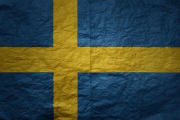 big national flag of sweden on a grunge old paper texture background