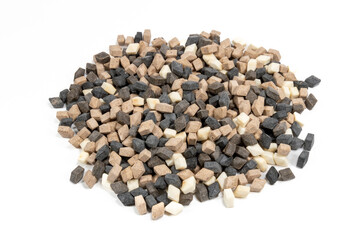 A pile of salty licorice in various colors on a white background