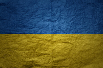 big national flag of ukraine on a grunge old paper texture background