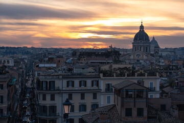 Fototapeta na wymiar View of the sunset from the top of the Spanish Steps near Barberini, in Rome, Italy.