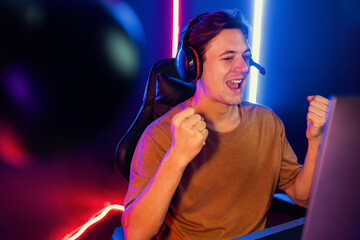 Host channel of gaming smart streamer playing online game to be winner, wearing headphone with...