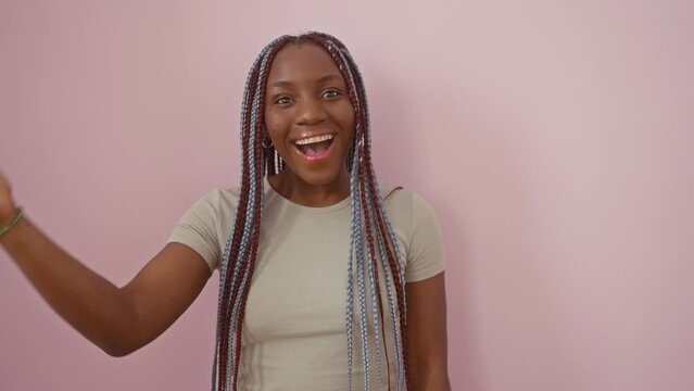 Frustrated african american woman smacks forehead, realizing her blunder. oops! forgot something! standing against an isolated pink background, her memory's failed her again.