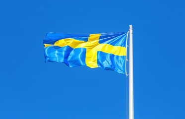 Swedish flag blowing in the wind on a sunny day - 783370671