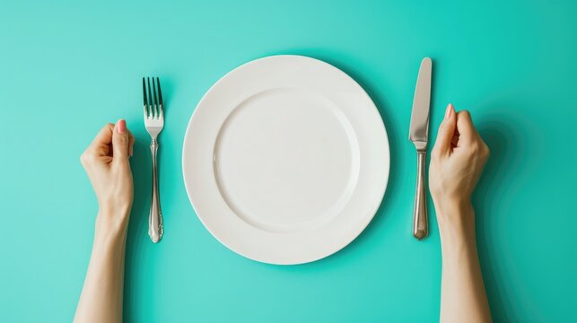 Woman with fork, knife and empty plate on color background, top view
