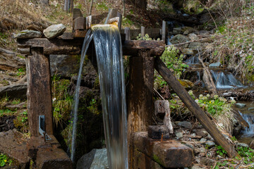 water flows through the chute of a watermill