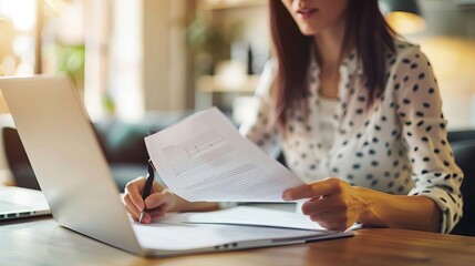 hr professional reviewing resumes and job applications for employee screening and candidate selection