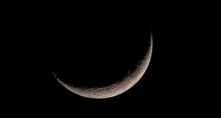 A closeup of the crescent moon shining in the night sky