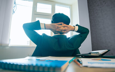 Man in his office resting with hand behind, business concept, stock photo