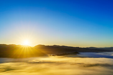 sunrise over valley of fog, clouds, sunset