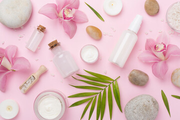 Composition with orchids, spa products on color background, top view