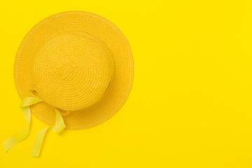 Yellow hat on color background, top view. Summer concept