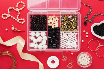 Tools and beads for making handmade jewelry on color background, top view
