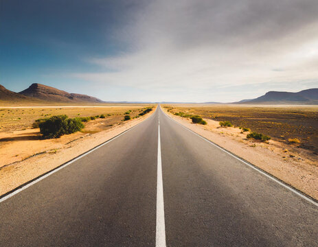 straight line road through an empty desert, a call to travel, explore, escape, a journey through the difficulties and trials of life, towards the unknown, adventure and freedom