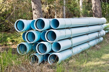 Pipes bundle for underground water mains construction, sewer pvc blue plastic industrial equipment...