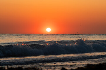 Sunset with broken wave