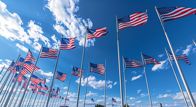 A field of American flags on a blue sky background, in a wide angle shot. Holiday concept for 4th of July, President's Day, Independence Day, US National Day, Labor Day, Fourth of July