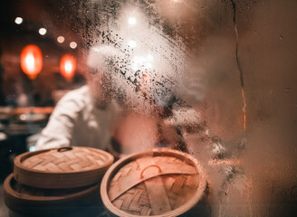condensation on the window in a Chinese kitchen with dim sum  wooden steamer basket