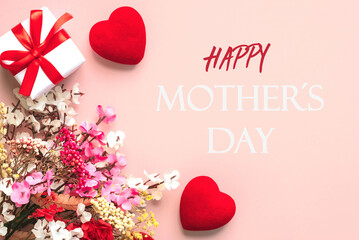 Happy Mother's Day. Top view of flowers,gift box and red hearts with the text Happy Mothers day