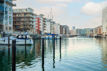 Boats and modern buildings at a Dockan Marina in Malmö, where boats dock in calm waters ....
