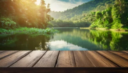 Foto op Canvas the empty wooden table top with blur background of summer lakes green forest high quality photo © Jayla
