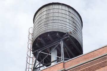 An old wooden water tower on an industrial building