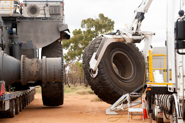 Huge tire being fitted to the chassis of a mining dump truck in Central Queensland, Australia