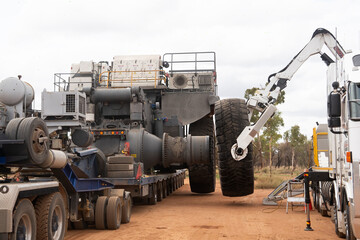 Huge tyre being fitted to the chassis of a mining dump truck in Central Queensland, Australia