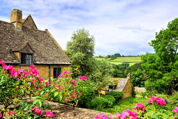 Cotswolds countryside view with flowers and quaint house, Snowshill, Gloucestershire, England
