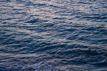small waves on the Mediterranean sea during sunset