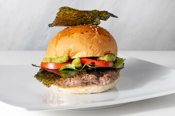 Beef burger with Japanese cuisine ingredients in center on clear background 