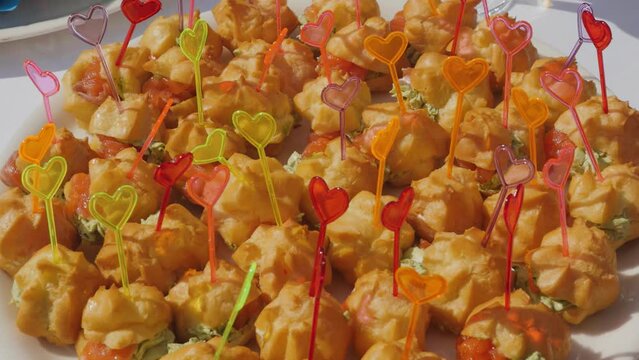 Snacks garnished with heart-shaped picks at a catered event