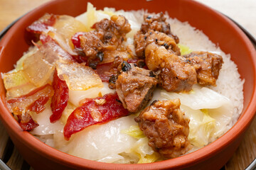 angle view clay pot rice of pork ribs and preserved meats and Chinese style sausage and cabbage horizontal composition