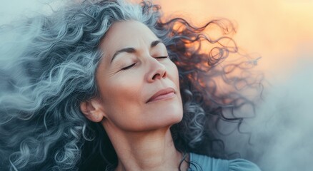 Serene mature woman enjoying a peaceful moment outdoors