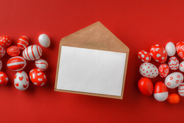 Easter banner with an envelope and Easter red and white eggs on a bright red background. A place to copy. Flat layout, top view.