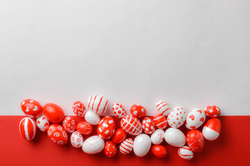 Easter backgrounds, a strip of Easter red and white eggs on a white-red background. Copy space. Flat lay, top view