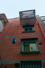 Bucket is pulled by a rope to a balcony to transport letters and small packages, Naples, Campania, Italy
