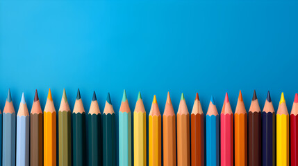 Row of Colored Pencils Against Blue Background