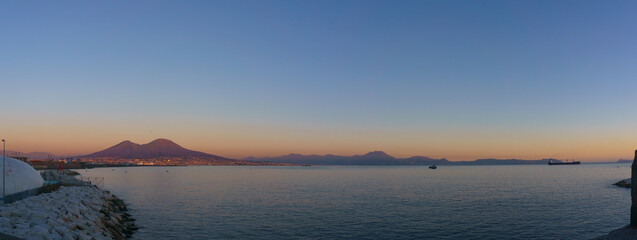 Panoramic view of mount Vesuvius over the city of Naples during golden hour at sunset, Naples, Campania, Italy