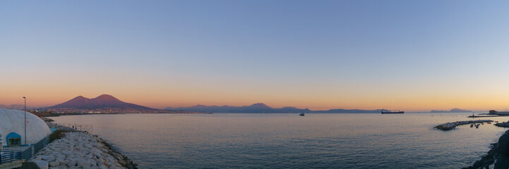 Panoramic view of mount Vesuvius over the city of Naples during golden hour at sunset, Naples,...