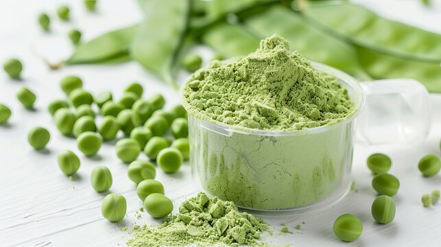 A plastic scoop filled with plant-based pea protein powder, accompanied by fresh green pea seeds, all against a white background. An isolated copy space for additional text or design elements