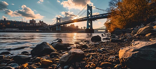 Solitude in Steel: A Majestic Suspension Bridge Stands Alone, Embracing the Urban Skyline with Grace and Grandeur, a Testament to Human Ingenuity and the Beauty of Engineering - obrazy, fototapety, plakaty