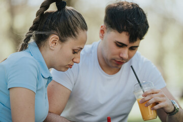 High school students are deeply absorbed in studying and discussing homework outdoors in an urban...