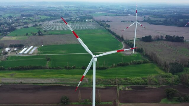 Close up of wind turbine. Aerial voew of wind mills farm park.