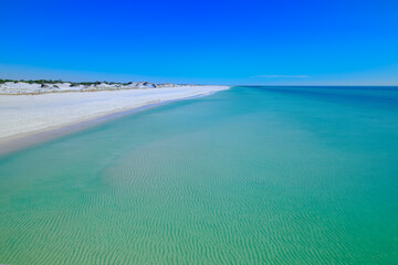 Calm emerald gulf of mexico water sugar white sand dunes at St. Andrews State Park Florida USA
