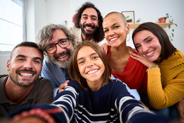 Joyful Caucasian family smiling hugging taking a selfie photo indoor. Three generations Caucasian...