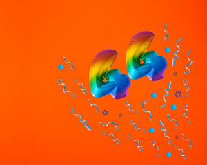 Confetti explosion with number 44 balloon - Celebration on orange background. Birthday card - obrazy, fototapety, plakaty